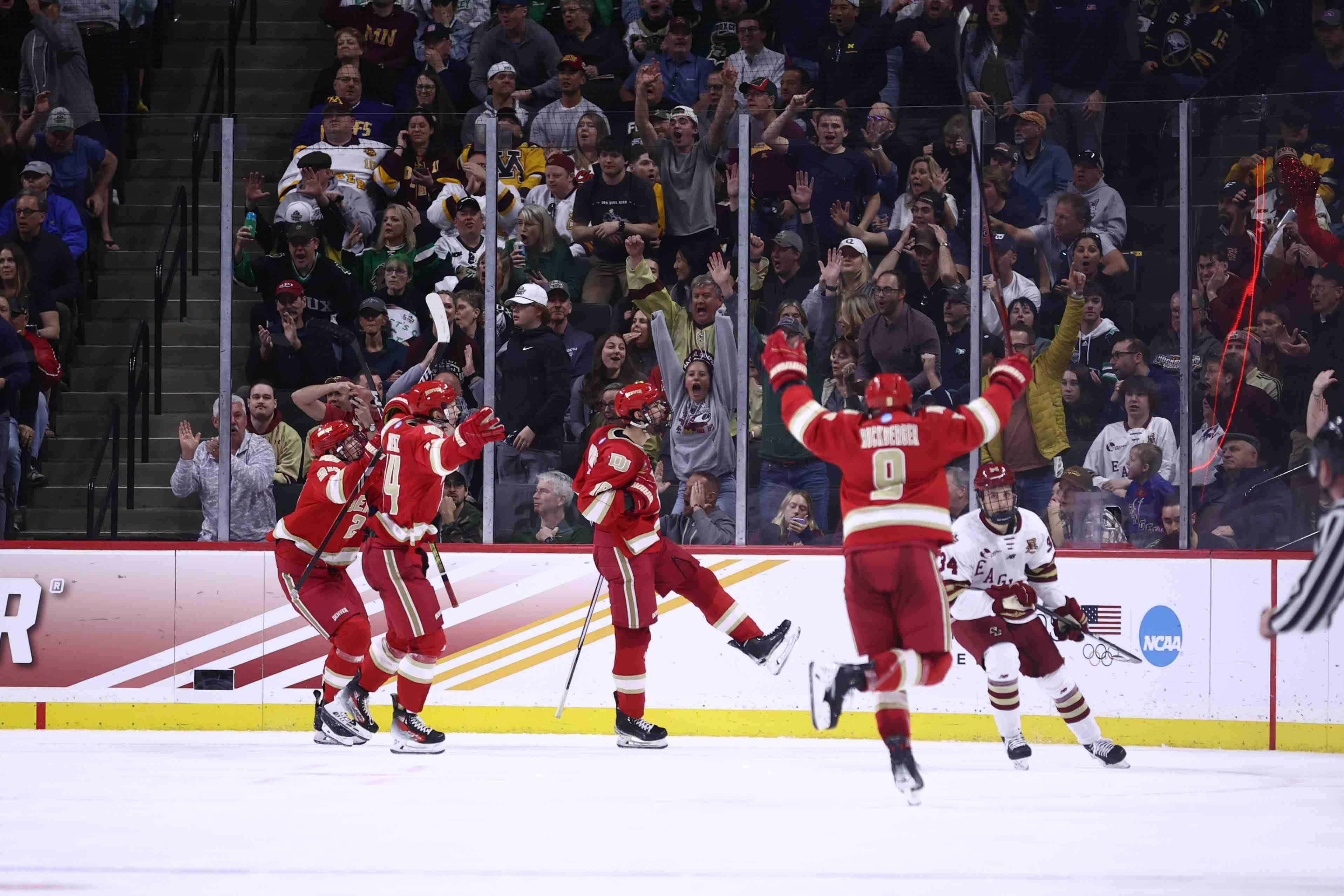 Denver hockey celebrates after scoring in the national championship
